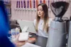 A cashier is using a POS system to process a payment from a customer. Anteprima dell’immagine prodotto