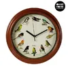A round wall clock with a wooden frame, featuring illustrations of various birds on its face. The clock has black hands and is set against a white background. Náhled obrázku produktu