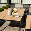 An outdoor dining set with a table and chairs, set up on a wooden deck with greenery in the background. Náhled obrázku produktu