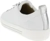 A close-up side view of a white sneaker with silver accents. Voir les images du produit