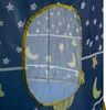 A close-up view of a blue children's play tent with a star and moon pattern, showing a mesh window with a yellow trim. Produktbild-Vorschau