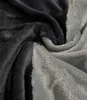 A close-up view of a folded plush blanket with a gradient of gray and anthracite colors. Náhled obrázku produktu