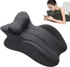A woman is lying on her stomach using a smartphone, supported by a dark gray wedge-shaped pillow. The pillow is designed to support the body in various positions. Produktbild-Vorschau