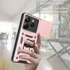 A hand holding a pink phone case with a ring holder, with a blurred indoor background. Produktbild-Vorschau