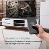 A hand holding a smartphone in front of a TV and audio equipment setup. Produktbild-Vorschau