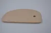 A wooden dough scraper on a light gray background. Produktbild-Vorschau