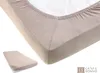 A close-up view of a beige fitted sheet on a mattress, with a smaller folded sheet in the bottom left corner. Produktbild-Vorschau