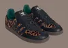 A pair of Adidas Samba OG sneakers with a leopard print accent. Produktbild-Vorschau