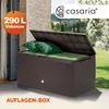 A brown storage box with its lid open, filled with green cushions and pillows, placed on a patio. Produktbild-Vorschau