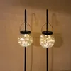 Two solar-powered garden lanterns with cracked glass globes filled with fairy lights, mounted on black poles. Produktbild-Vorschau