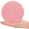 A hand holding a round red and white checkered fabric circle. Produktbild-Vorschau