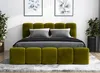 A modern bedroom with a green upholstered bed and two framed pictures on the wall. Produktbild-Vorschau
