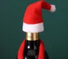 A wine bottle decorated with a Santa hat and scarf. Náhled obrázku produktu