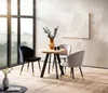 A round wooden dining table with three chairs in a well-lit room with large windows. Anteprima dell’immagine prodotto
