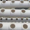 A close-up view of a hydroponic growing system with multiple layers of white pipes and circular openings for plants. Podgląd zdjęcia produktu