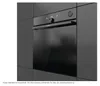 A close-up view of a modern black oven integrated into a dark gray kitchen. Produktbild-Vorschau