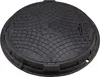 A black, round manhole cover with a textured surface and a grid pattern. Produktbild-Vorschau