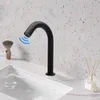 A black faucet with an infrared sensor is shown in a bathroom setting, with blue waves indicating the sensor's range. Podgląd zdjęcia produktu