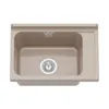 A top-down view of a beige sink basin with a drain and a ribbed draining board. Anteprima dell’immagine prodotto