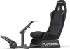 A black gaming chair with a pedal stand and a small table attached. Produktbild-Vorschau