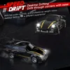 Two black remote control drift cars with yellow accents on a dark, textured surface. Produktbild-Vorschau