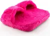 A fluffy pink slipper is shown against a white background. Náhľad obrázku produktu