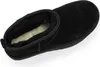 A top-down view of a black UGG boot with a cream-colored fuzzy lining. Voir les images du produit