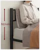 A person sitting on a bed frame. Náhled obrázku produktu