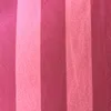 A close-up view of striped fabric in shades of red and pink. Produktbild-Vorschau
