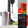 A stand mixer with a metal cup and a recipe for a tomato drink. Produktbild-Vorschau