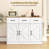 A white sideboard with a wooden top, featuring three drawers and three cabinet doors, is displayed in a room setting. Decorative items like a mini oven, bowls, and a bottle of liquor are placed on top. Náhľad obrázku produktu