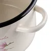 Close-up of the handle and rim of a cream-colored pot with a black rim and a floral design. Produktbild-Vorschau