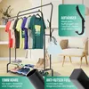 A clothing rack with clothes and shoes, next to a chair and a bag, with marketing overlays. Produktbild-Vorschau
