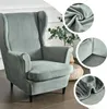 A light gray wingback chair with a velvet slipcover, shown with close-up details of the fabric and corners. Podgląd zdjęcia produktu
