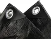 Close-up of two reinforced corners of a black tarp, showing the grommets. Produktbild-Vorschau