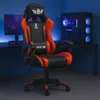 A gaming chair is set up in a room with a computer and monitor. Náhľad obrázku produktu