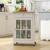 A white kitchen cart with a wooden top is shown in a kitchen setting. Podgląd zdjęcia produktu