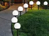 Solar garden lights illuminating a pathway and lawn at dusk. Náhľad obrázku produktu