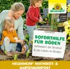 A woman and two children are planting in a garden. Produktbild-Vorschau