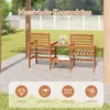 A wooden patio furniture set with two chairs and a table, set on a concrete patio with a garden and fence in the background. Náhľad obrázku produktu