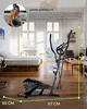 An elliptical trainer is shown in a living room setting with a bed and furniture in the background. There is also a picture of a woman in the top left corner. Produktbild-Vorschau