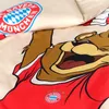 A close-up view of a duvet cover featuring a cartoon bear character wearing a FC Bayern München jersey. Podgląd zdjęcia produktu