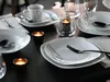 A table setting with plates, cups, cutlery, and candles. Náhľad obrázku produktu