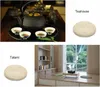 A collage of images showing a tea set, a round cushion, and a Japanese-style room with tatami mats and a window. Produktbild-Vorschau