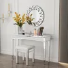 A vanity table with a mirror and stool, decorated with flowers and makeup. Anteprima dell’immagine prodotto