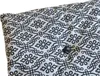 A close-up view of a cushion with a black floral pattern on a white background. Náhľad obrázku produktu
