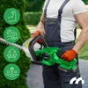 A person in overalls and orange gloves holds a green electric hedge trimmer next to a green hedge. Four green circular icons with white line drawings are displayed on the left side of the image. Podgląd zdjęcia produktu