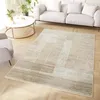 A modern living room with a sofa, armchair, coffee table, and a rug. Produktbild-Vorschau