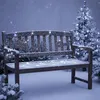A wooden bench covered in snow and decorated with fairy lights, with a snow-covered Christmas tree in the background. Produktbild-Vorschau