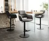 Three bar stools are arranged around a table in a modern kitchen or dining area. Produktbild-Vorschau